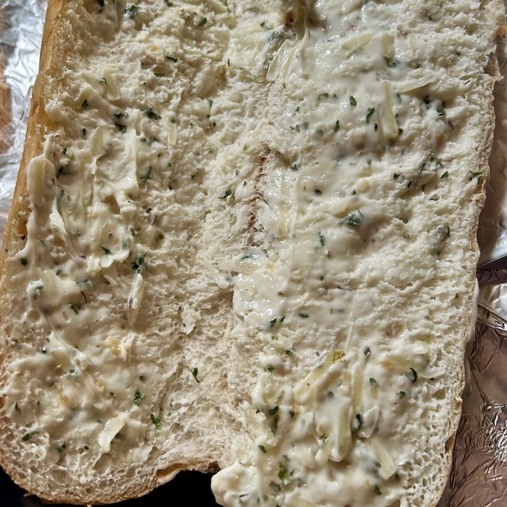 Golden brown gluten-free garlic bread made with hoagie rolls, butter, Parmesan, and fresh herbs, wrapped in foil and baked to perfection.
