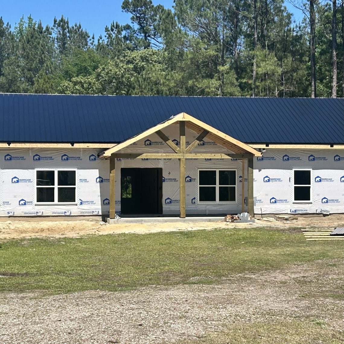 Custom home finishes: black metal roof and white grid-less windows