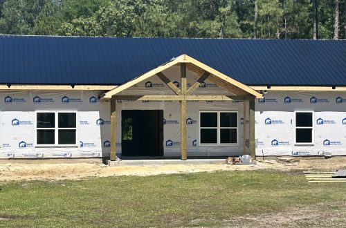 Custom home finishes: black metal roof and white grid-less windows