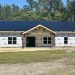 Custom home finishes: black metal roof and white grid-less windows
